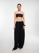 Black balloon trousers by MOSAÏKA styled with strapless top on model