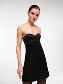 Black bustier mini dress by MOSAÏKA worn on model angled pose