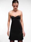 Black bustier mini dress by MOSAÏKA worn on model soft relaxed pose
