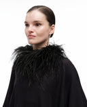 Feather boa collar by MOSAÏKA styled on model from side creating soft dramatic volume around the neckline