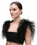 Feather boa straps by MOSAÏKA styled on model shoulder adding dramatic volume