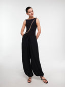 Black Pearl Wave bodysuit by MOSAÏKA worn on model with flowing trousers