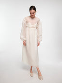 Off-white water lily dress by MOSAÏKA worn on model in walking pose